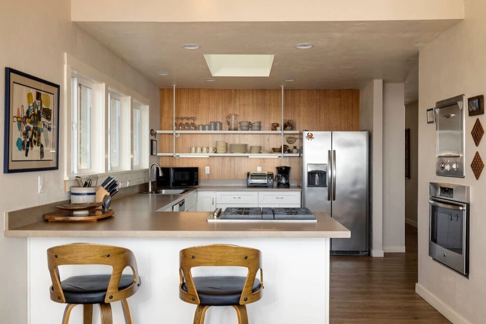 Cook and connect in the fully equipped kitchen, designed with modern appliances and plenty of counter space. Whether it’s a big family meal or a quick snack, this space makes gathering around food easy and enjoyable.