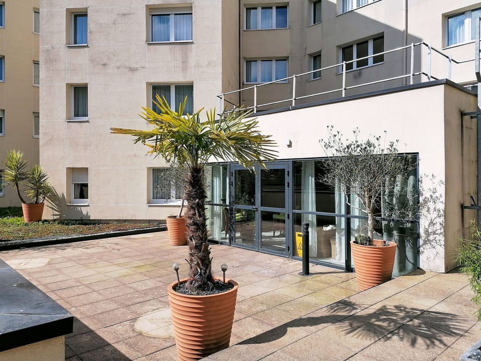 Courtyard exterior view showing the building's rear facade and outdoor surroundings.
