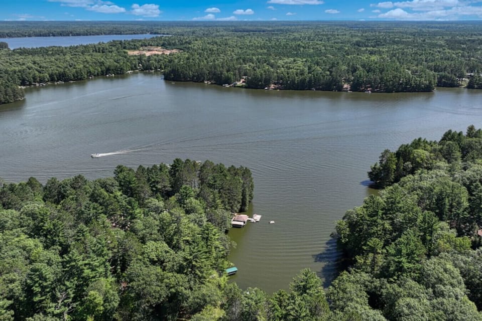 Stunning aerial of the lake and lush forest.