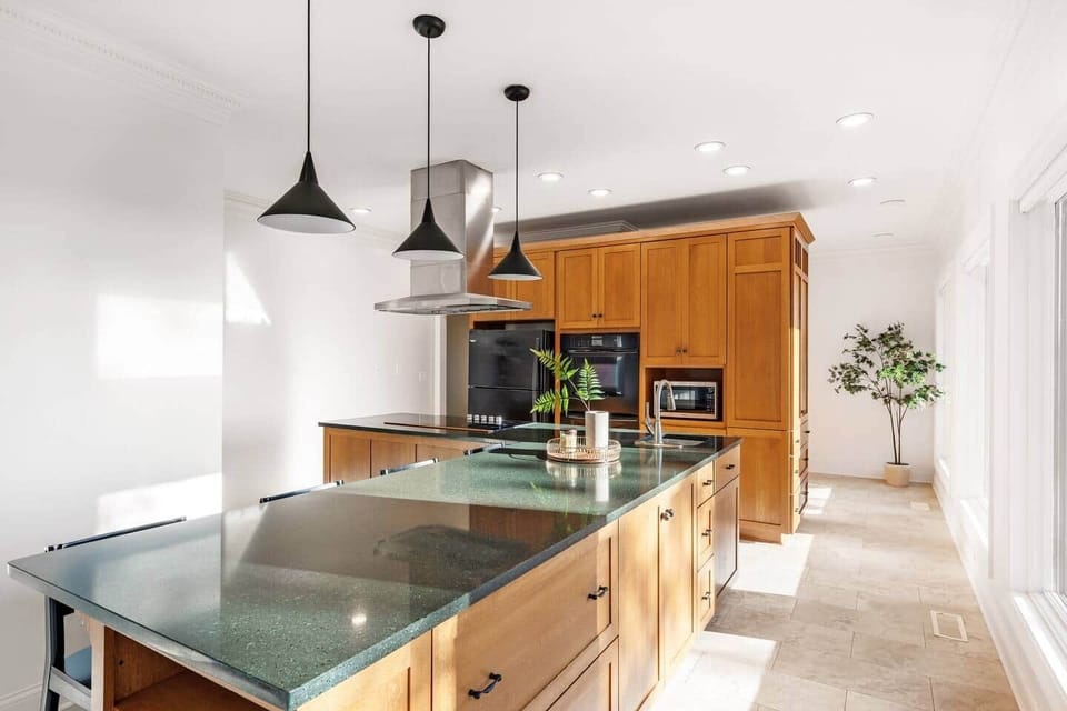 Expansive Chefs kitchen-complete with double ovens and flattop electric cooktop. Bar seating for four.