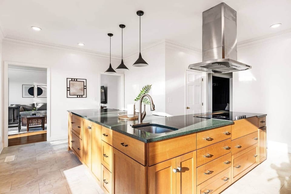 A kitchen in the clouds, where horizons stretch endlessly and every moment invites togetherness. Expansive Chefs kitchen-complete with produce sink, double ovens and flattop electric cooktop.