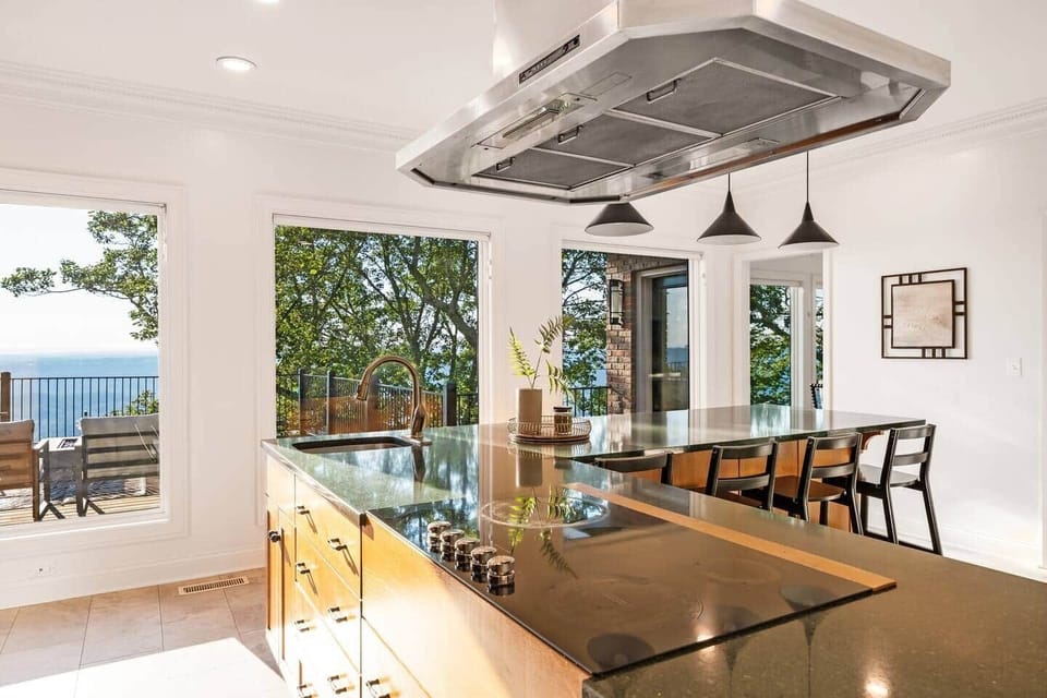 Expansive Chefs kitchen-complete with new double convection ovens and flattop electric cooktop.