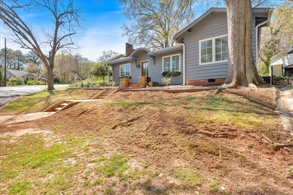 The house welcomes you with an inviting entrance and a well-maintained walkway.