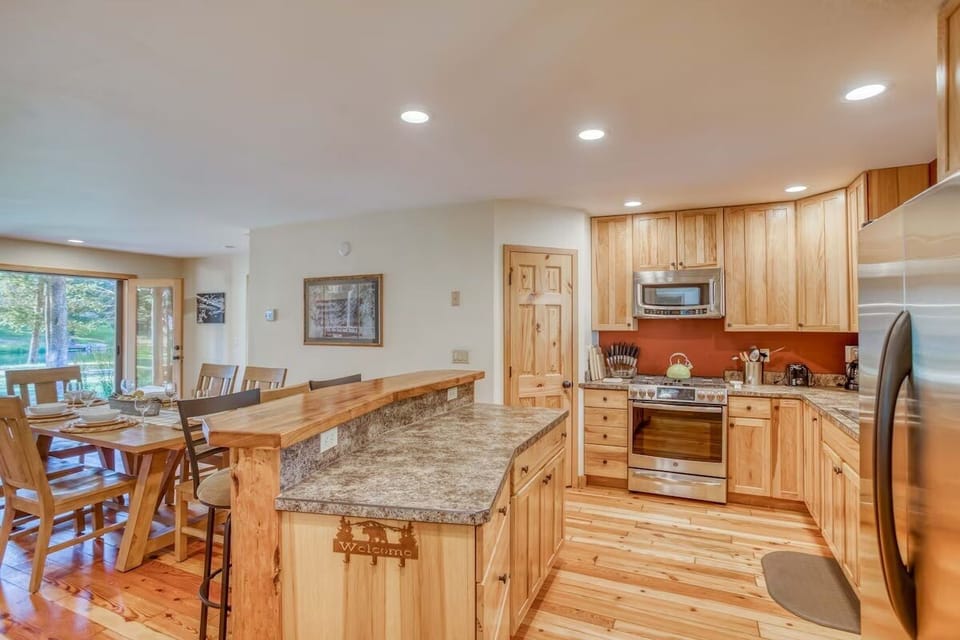Open kitchen and dining and with ample cooking supplies for meals at home.