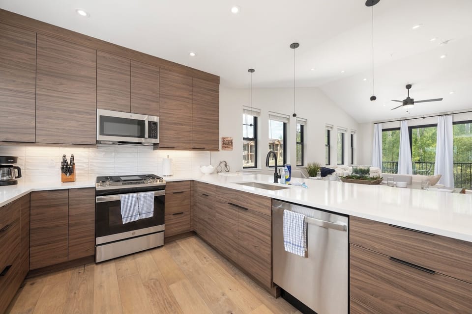 Open concept dining / kitchen area with breakfast bar and fully stocked kitchen