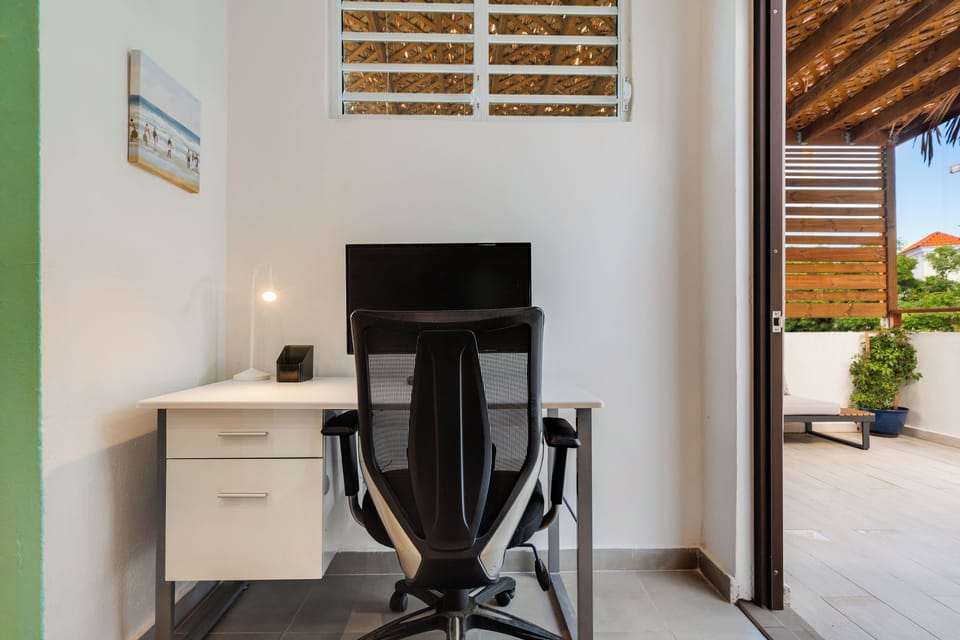 A secluded nook with a large desk and a comfortable chair, perfect for focusing.

