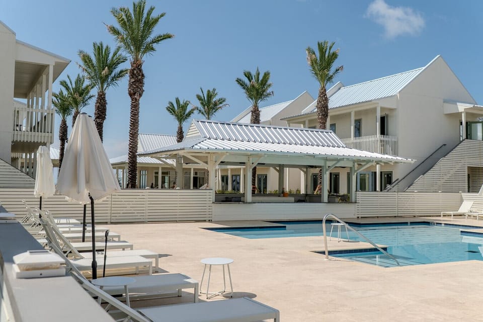 Resort-style pool with a sun deck and shaded cabana lounge—your perfect Pass Christian hideaway starts here.