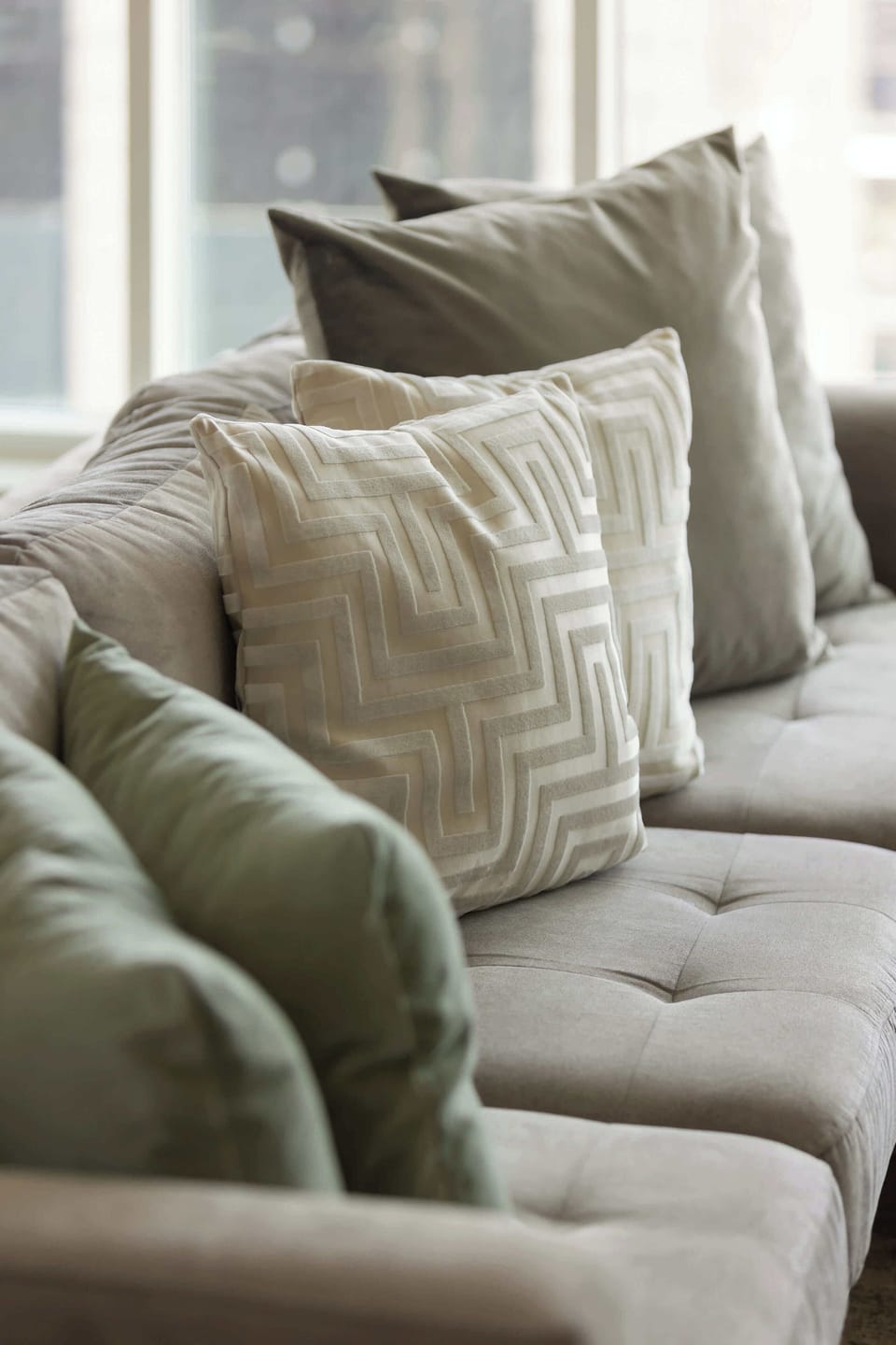 A detailed image of the plush cushions on the sofa, showcasing a mix of textures and colors that add warmth and comfort to the living space.