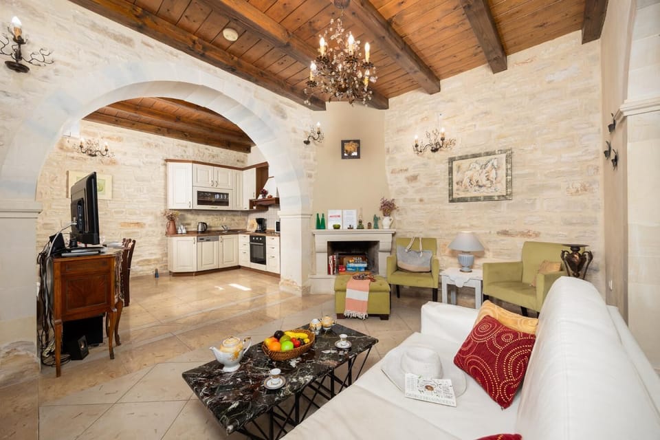 Unit 2 - open-plan living room with sofa, dining area, kitchen, ornamental fireplace, A/C, WiFi internet, and satellite TV