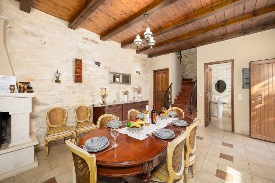 Unit 1 - open-plan living room with sofa, dining area, kitchen, ornamental fireplace, A/C, WiFi internet, and satellite TV