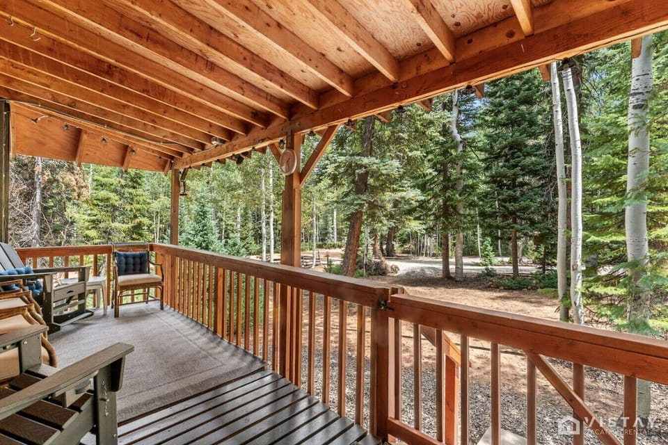 Covered patio with comfortable outdoor seating, perfect for relaxing and enjoying the fresh mountain air.