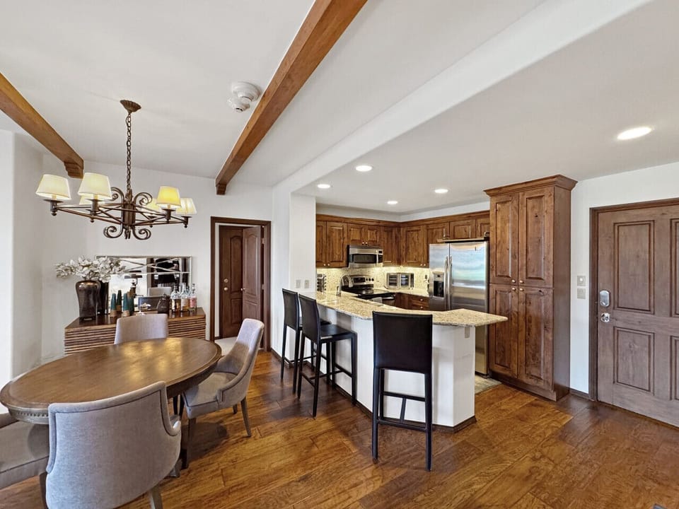 The full kitchen island with seating fosters social dining.  Unlike hotel rooms, cook, eat, and bond in an open layout, perfect for group ski trips. Enjoy home-like comfort