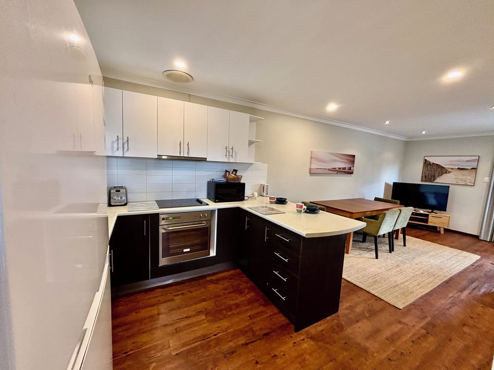 Even a dishwasher!! Quality appliances, induction stove top, oven, full sized fridge, microwave, kettle, toaster, coffee pod machine & kitchenware.