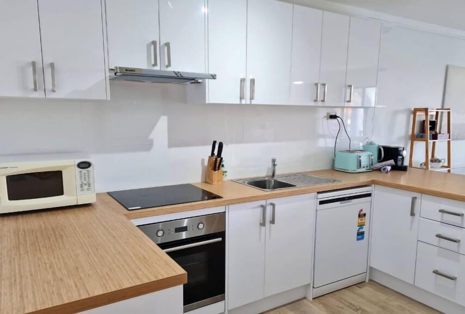 Kitchen with full fridge, microwave, oven & stove, dishwasher, coffee maker, kettle & toaster & all you need to cook & serve up a family feast.
