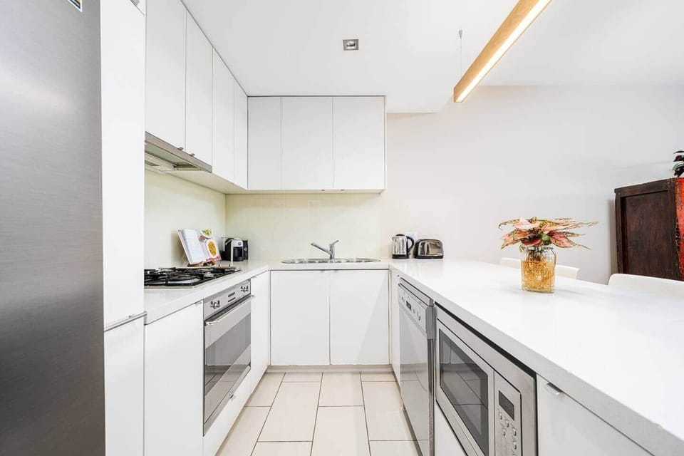 Fully equipped kitchen with: Smeg gas stovetop, oven, dishwasher, microwave, coffee machine, milk frother, kettle and toaster.