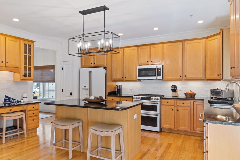 main floor kitchhen has a desk with a printer below, island seating for 2-3