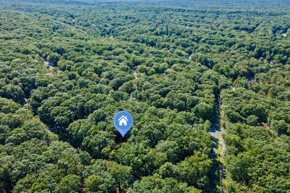 Take in the Pocono Mountains from the drone's altitude — a sea of trees with just enough rooftops and roads visible to confirm you're not completely off the grid out here.