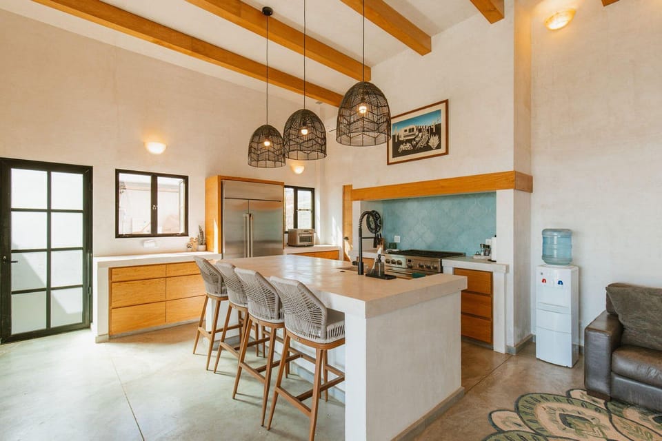 Open-concept kitchen with ocean views and local ceramics.