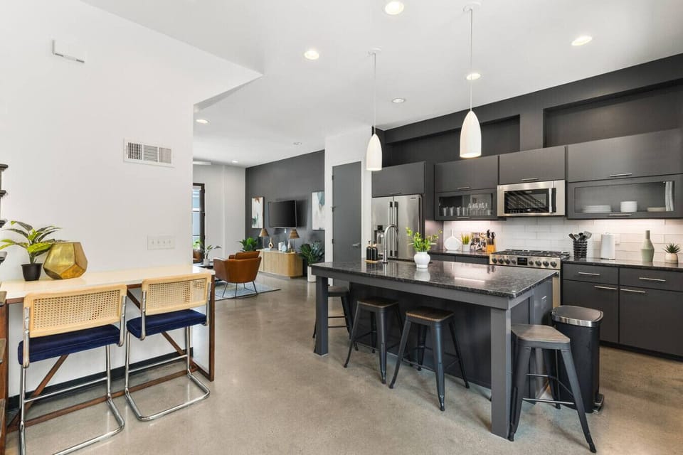 Updated, fully-equipped kitchen with high-end appliances and seating for four at the counter.