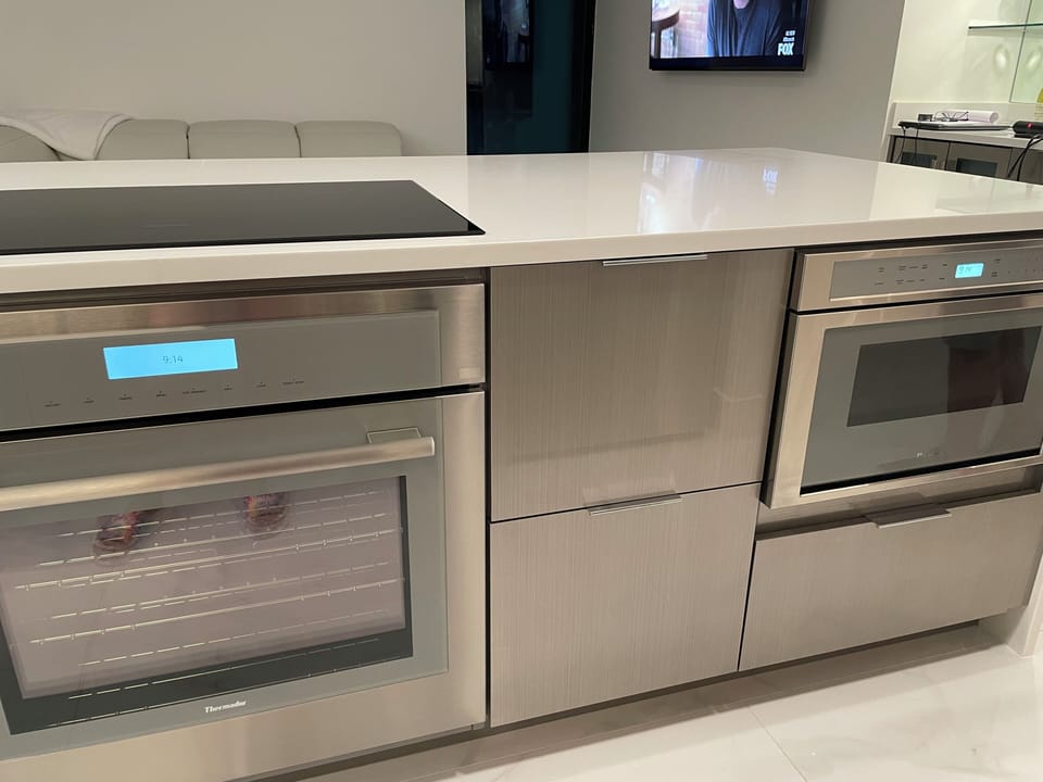 Kitchen with induction cooktop and stove. Microwave to the right