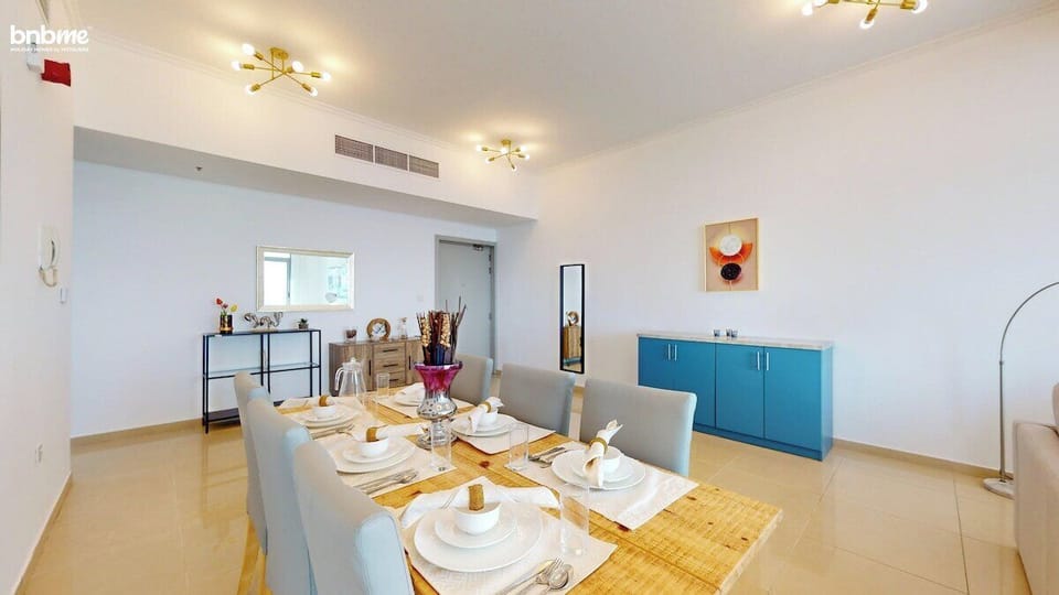 Host stylish meals in this chic dining area featuring a contemporary table set for six, warm lighting, and modern decor—perfect for family dinners, casual brunches, or entertaining guests in your Dubai Marina apartment.