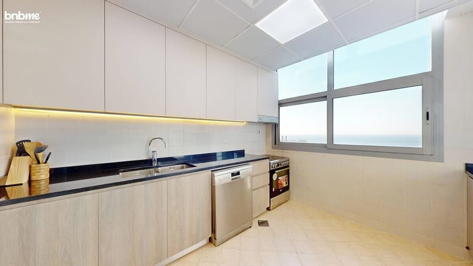 Whip up delicious meals in this sleek full kitchen featuring stainless-steel appliances, a gas stove, dishwasher, and a large fridge. Ample cabinet storage, natural light, and stunning sea views make it a dream setup for every guest chef.