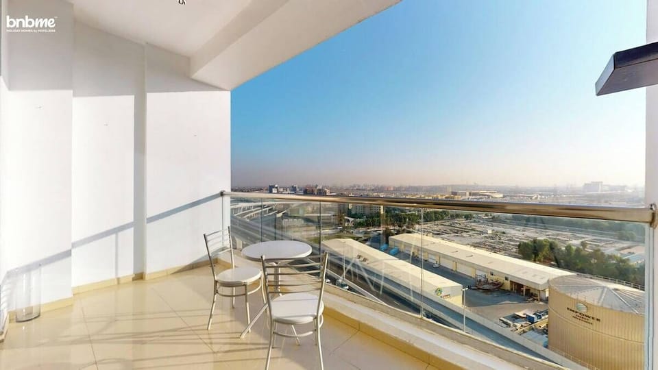 Unwind with your morning coffee or a sunset chat on your spacious private balcony, featuring skyline views and comfy outdoor seating—your breezy escape above the city.
