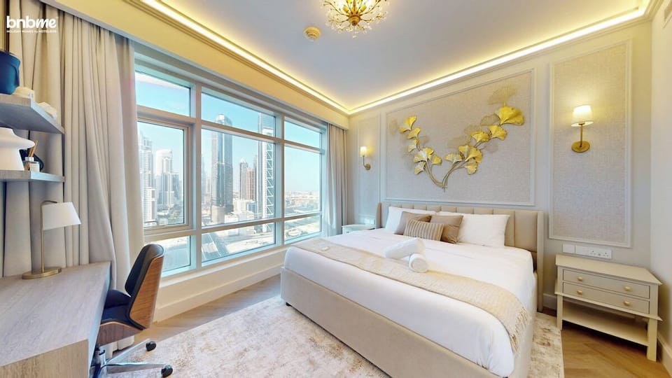 Wake up to city skyline views from this elegant bedroom featuring a plush king bed, built-in wardrobes, smart TV, and a dedicated workspace—perfect for business travellers, couples, or anyone seeking luxury and comfort in Downtown Dubai.