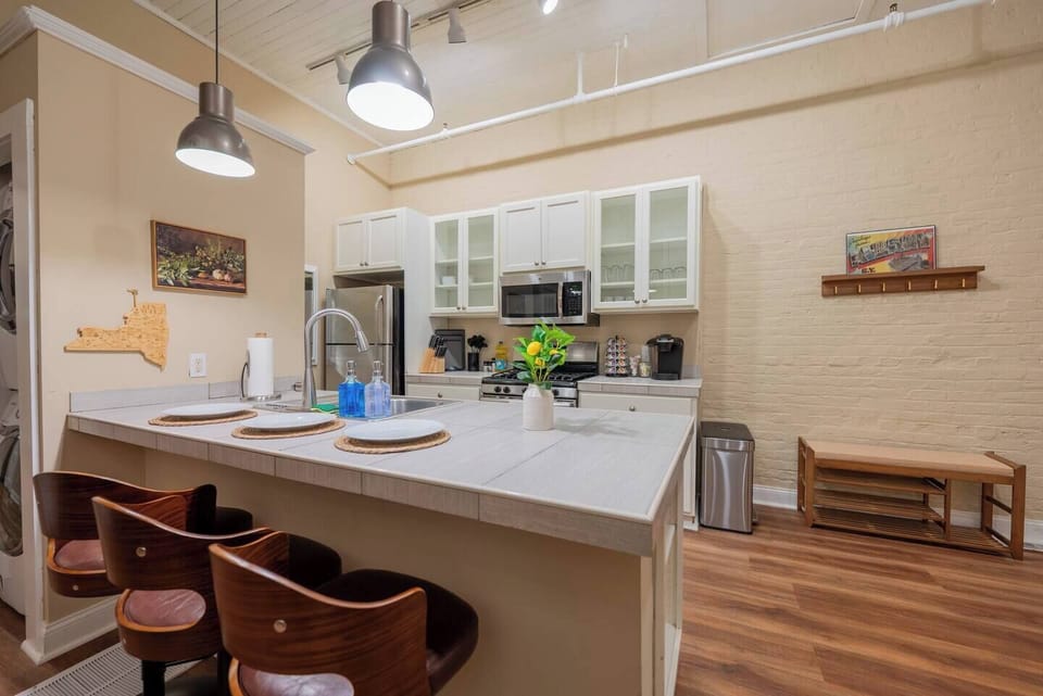 Enjoy cooking in the fully equipped kitchen, then gather around the island bar for dining or drinks under stylish pendant lighting.