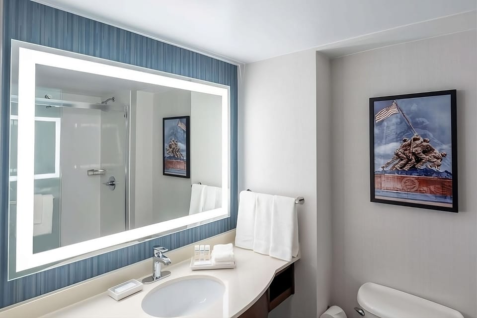 Refresh effortlessly with a glowing mirror and tidy vanity.
