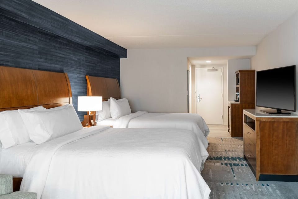 Stretch out on plush beds under warm, bedside lighting.