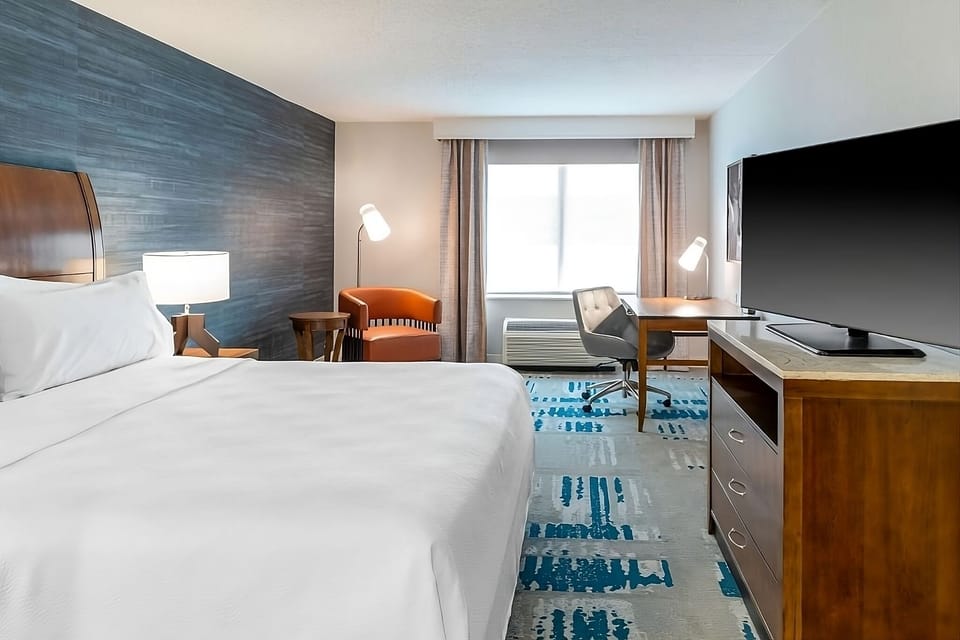 Unwind in a bright king room with workspace comfort.