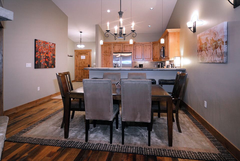 Spacious dining area with seating for six, open to kitchen and living room