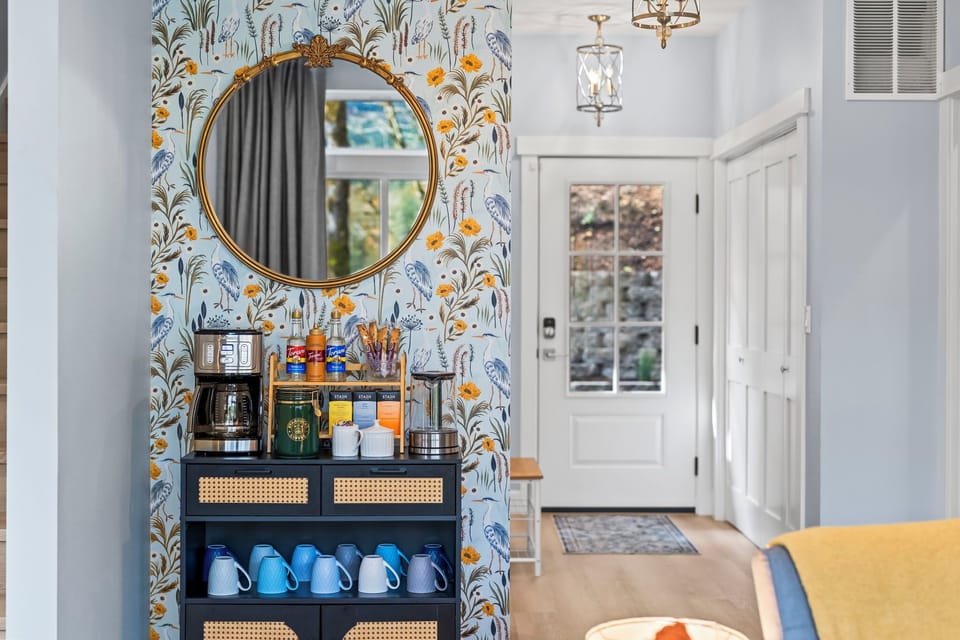 Vibrant floral wallpaper and a stylish coffee corner invite delightful mornings!