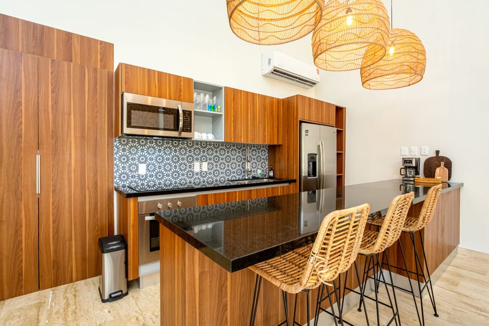 Enjoy a fully equipped kitchen with a convenient breakfast bar and stools — perfect for casual meals, morning coffee, or chatting while you cook.