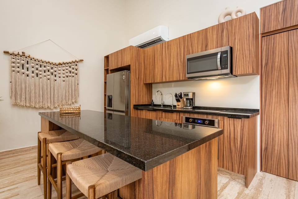 Spacious, fully-equipped kitchen with breakfast bar & stools — cook, chat & gather in style
