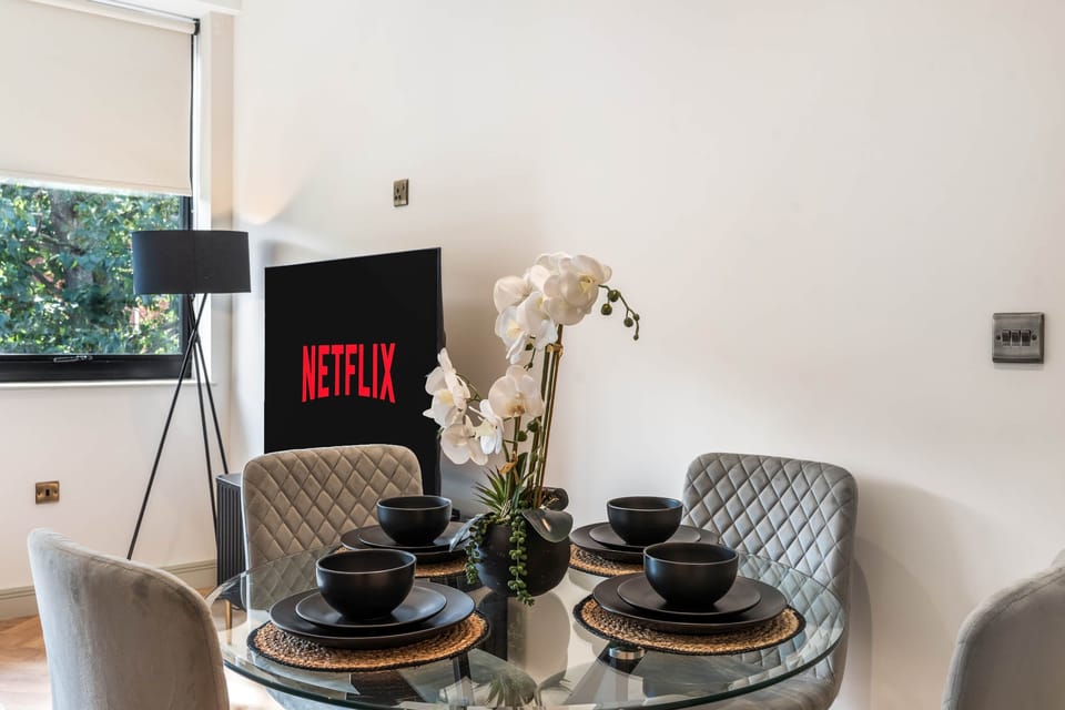 Dining table seating four guests, ideal for meals or remote working.