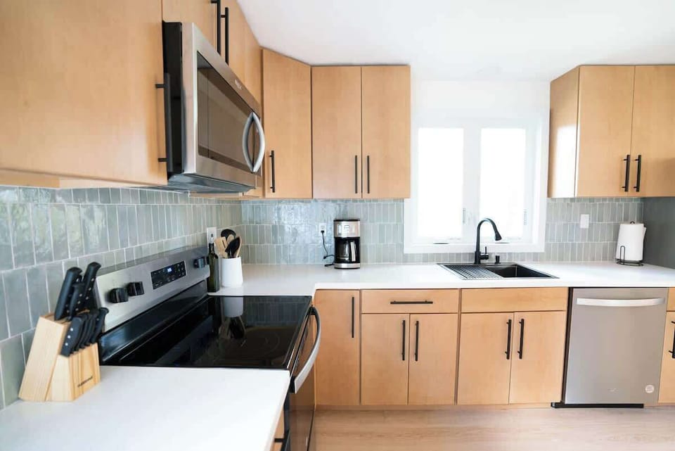 Create delicious meals in the fully equipped kitchen featuring a brand-new oven, refrigerator, and everything you need for a culinary adventure.