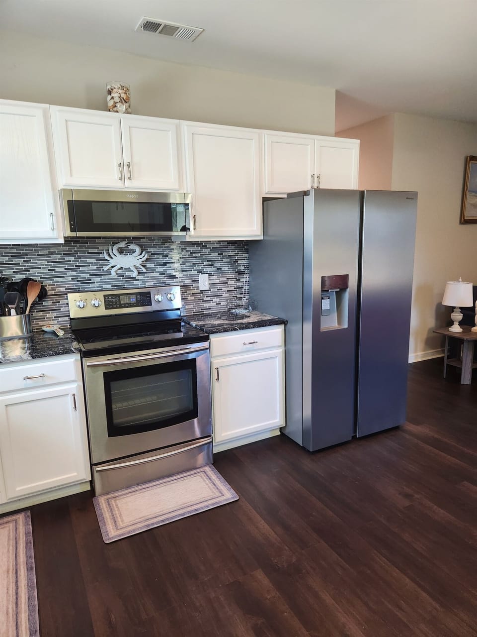 From the sleek refrigerator to the sparkling countertops, this kitchen blends everyday convenience with a splash of style