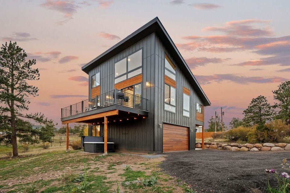 Sleek exterior lines and an elevated deck invite you outdoors with forest views.