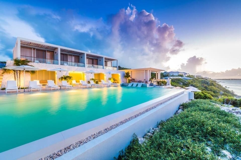 Unwind in the sunset-lit infinity pool above the sea.