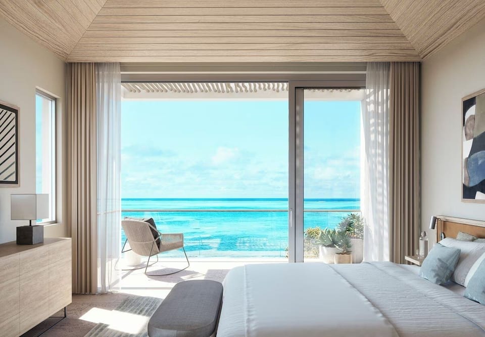 Wake up to sunrise views through expansive oceanfront glass.