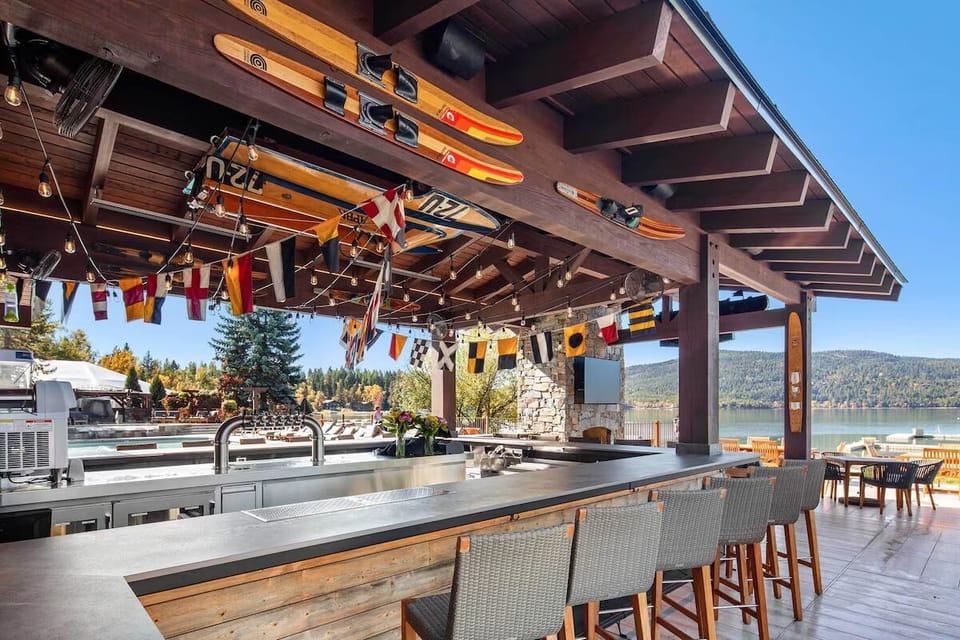 Sip cocktails at the lakeside bar under festive lights.