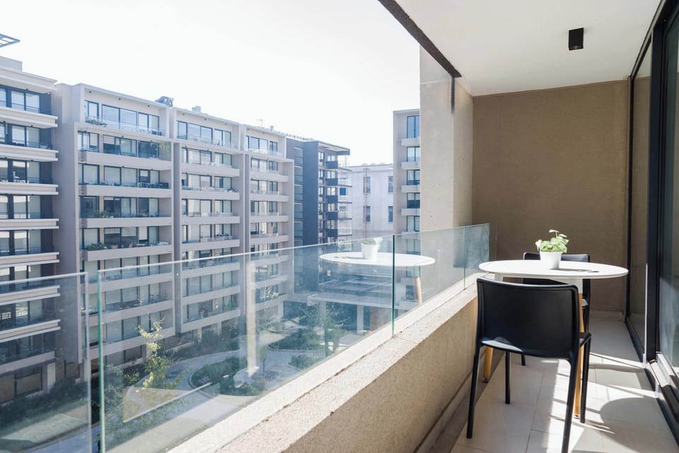 Enjoy your morning coffee on this serene balcony with a view of the cityscape.