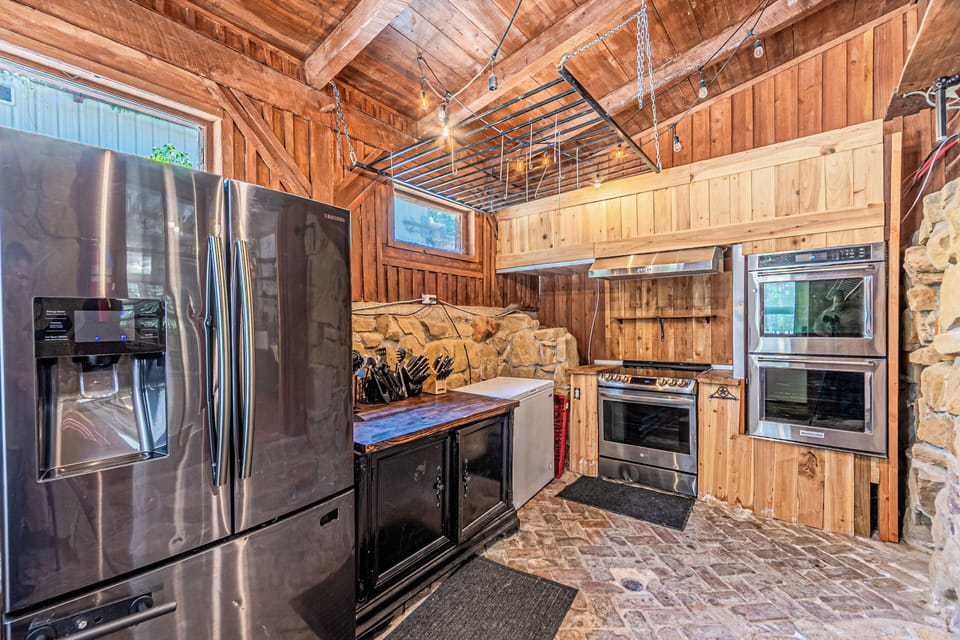 More kitchen space with a second full size fridge, double ovens plus a 3rd range option with cooktop