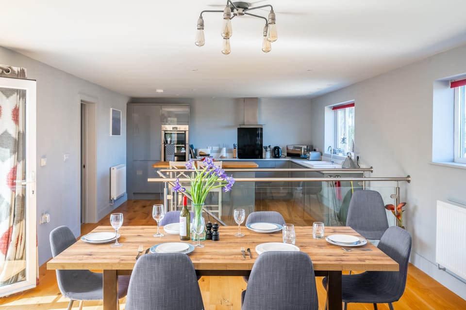 First floor: Dining table with kitchen