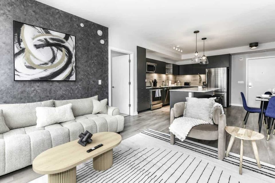 Chic and bright living room with cozy couch, flatscreen Tv and dedicated work station