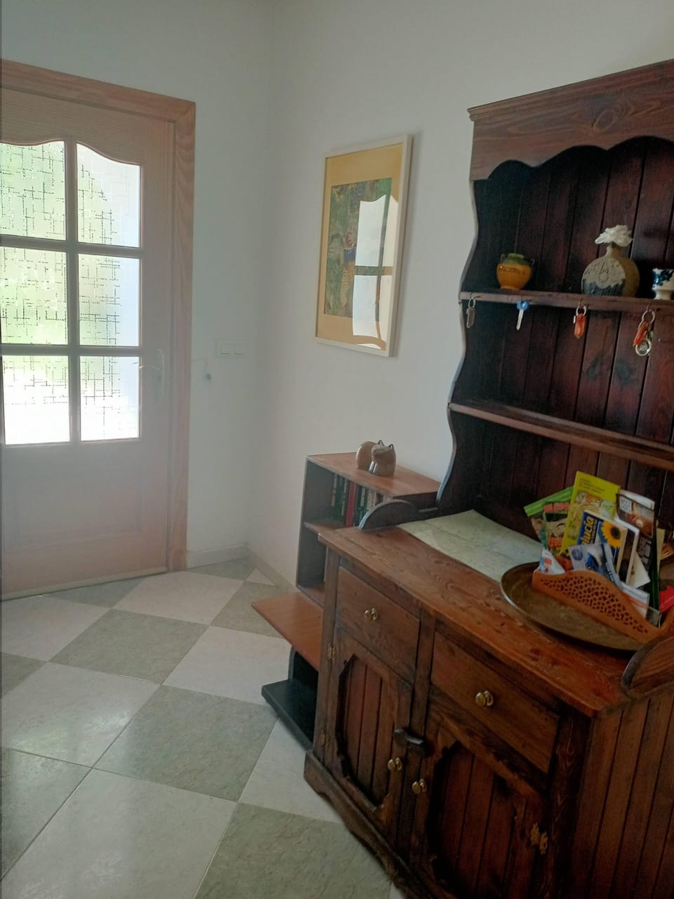 The hall: looking towards the front door. A dresser in the foreground.