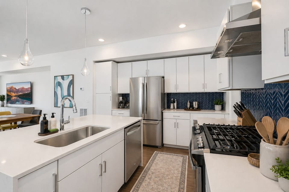 The fully-stocked kitchen features a gas range, stainless steel appliances, and quartz countertops. 