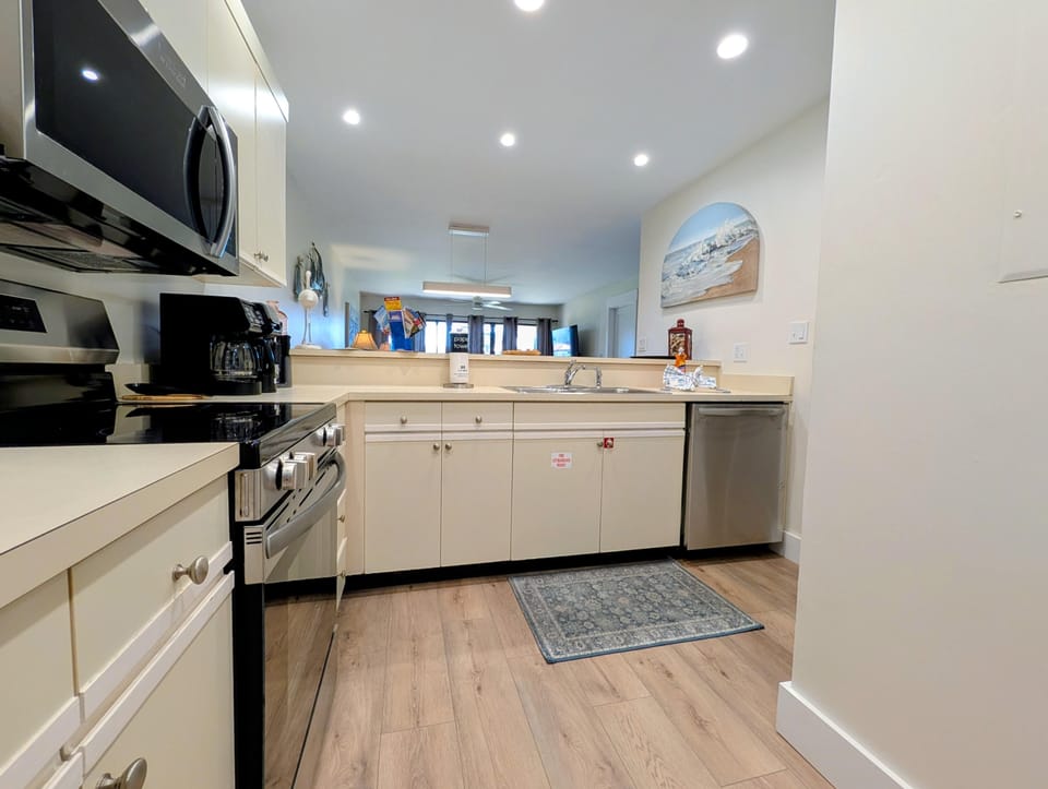 Bright, modern kitchen with stainless steel appliances and open layout